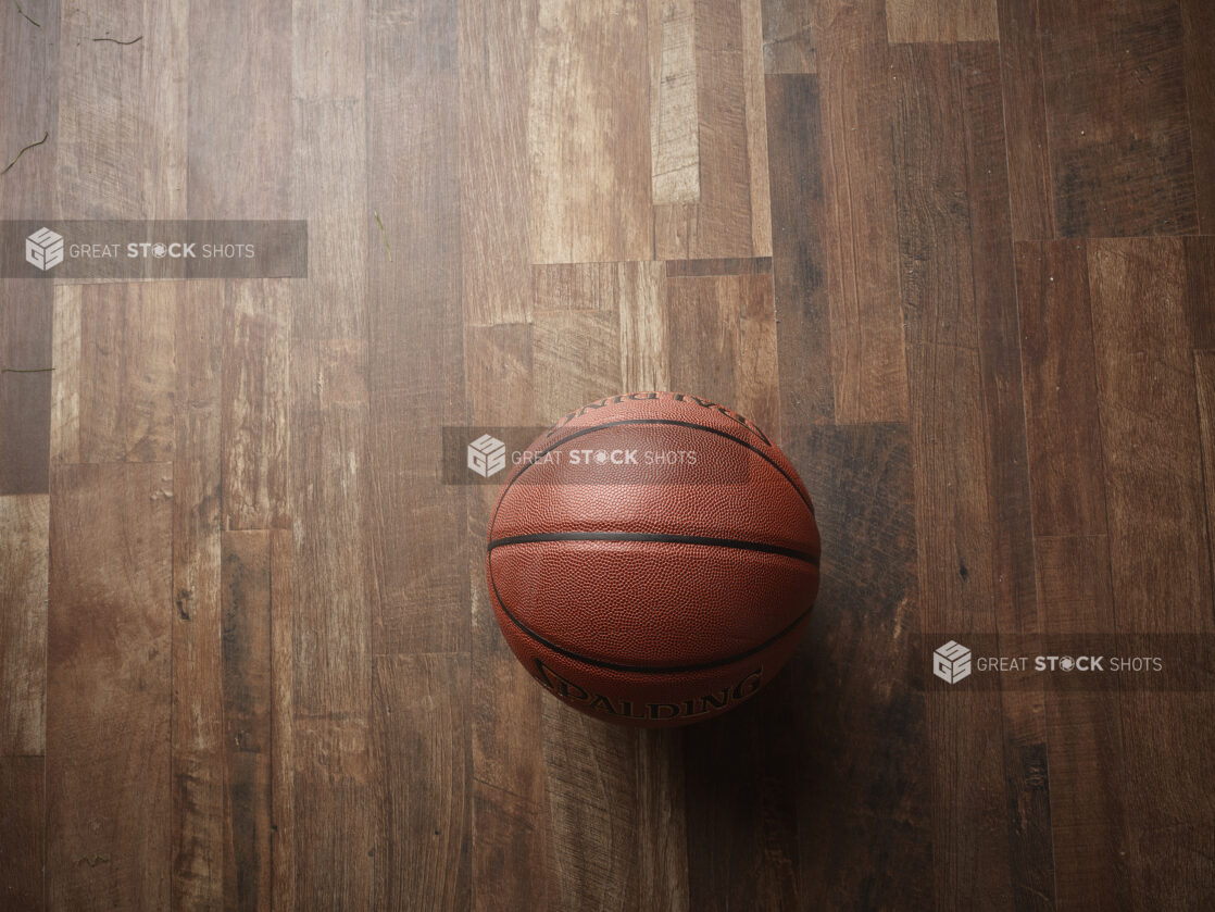 Overhead View of a Spalding Basketball on a Wooden Flooring Surface