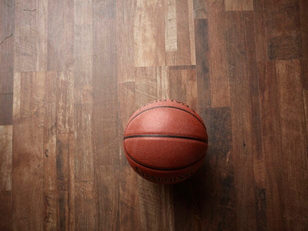Overhead View of a Spalding Basketball on a Wooden Flooring Surface
