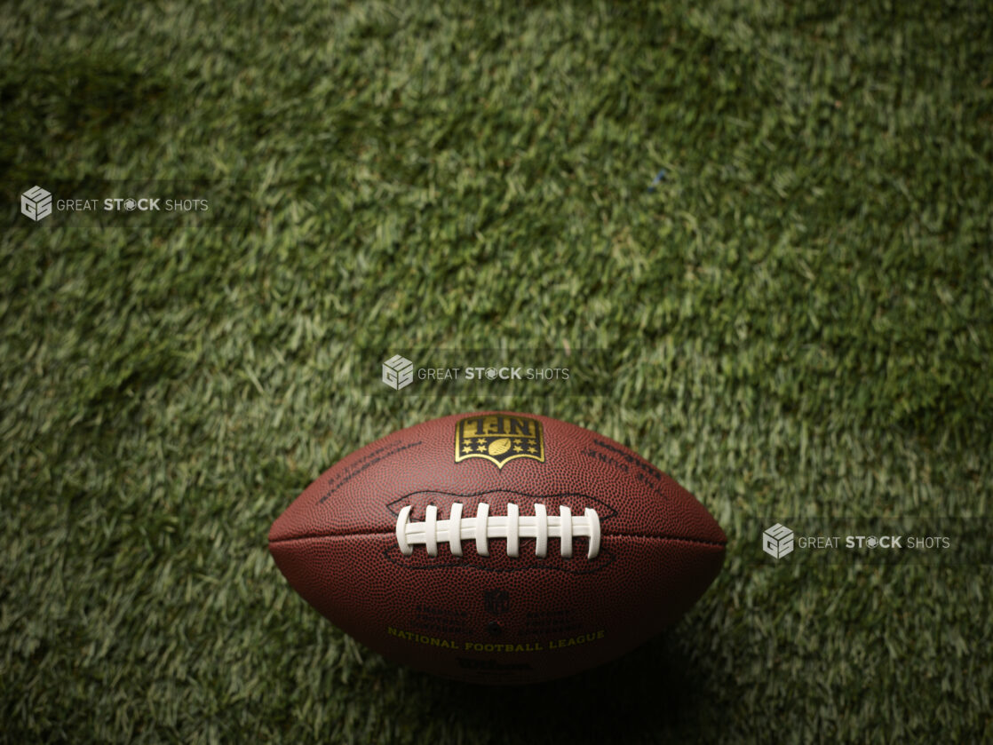 Overhead View of an American Football on Astroturf in an Outdoor Setting