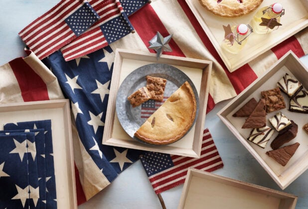 Overhead Group Shot of Assorted Pies, Brownies, Squares and Desserts in Wood Serving Catering Trays for an American Celebration or Fourth of July Party