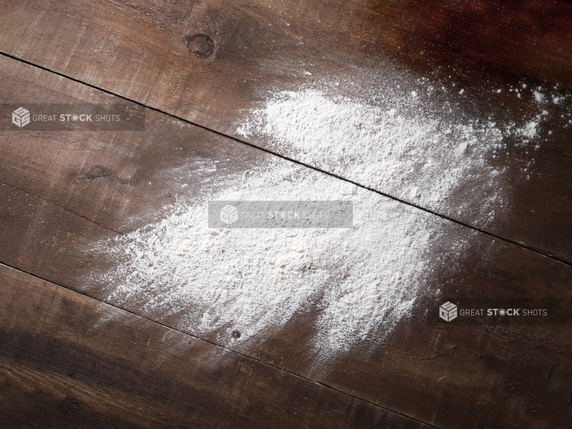 Overhead View of Flour Thrown Across a Dark Wooden Panelled Surface