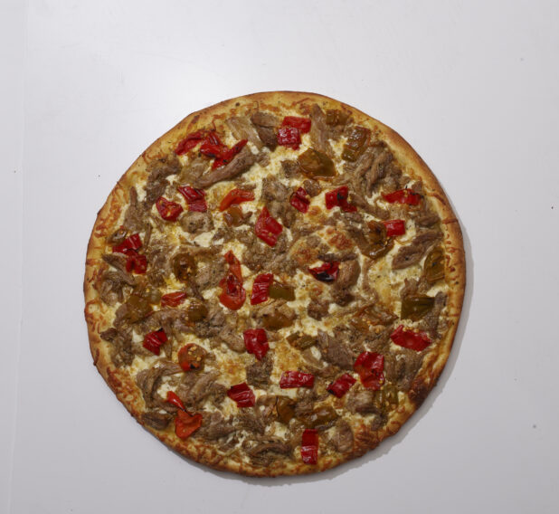Overhead View of a Whole Specialty Pizza with Porchetta and Hot Banana Peppers Toppings, on a White Background for Isolation