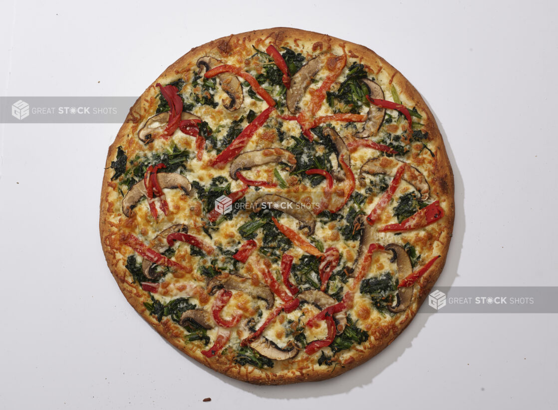 Overhead View of a Whole Specialty Pizza with Portobello Mushrooms, Sautéed Spinach and Roasted Red Peppers, on a White Background for Isolation