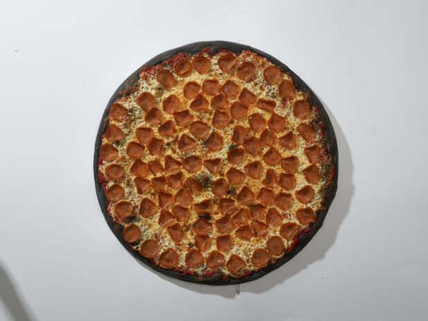 Overhead View of a Whole Charcoal-Infused Pizza with Pepperoni and Cheese, on a White Background for Isolation