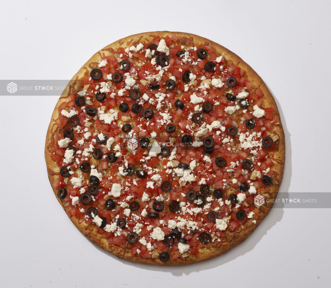 Overhead View of a Whole Specialty Greek Pizza with Black Olives, Feta Cheese, Roasted Garlic and Bruschetta, on a White Background for Isolation