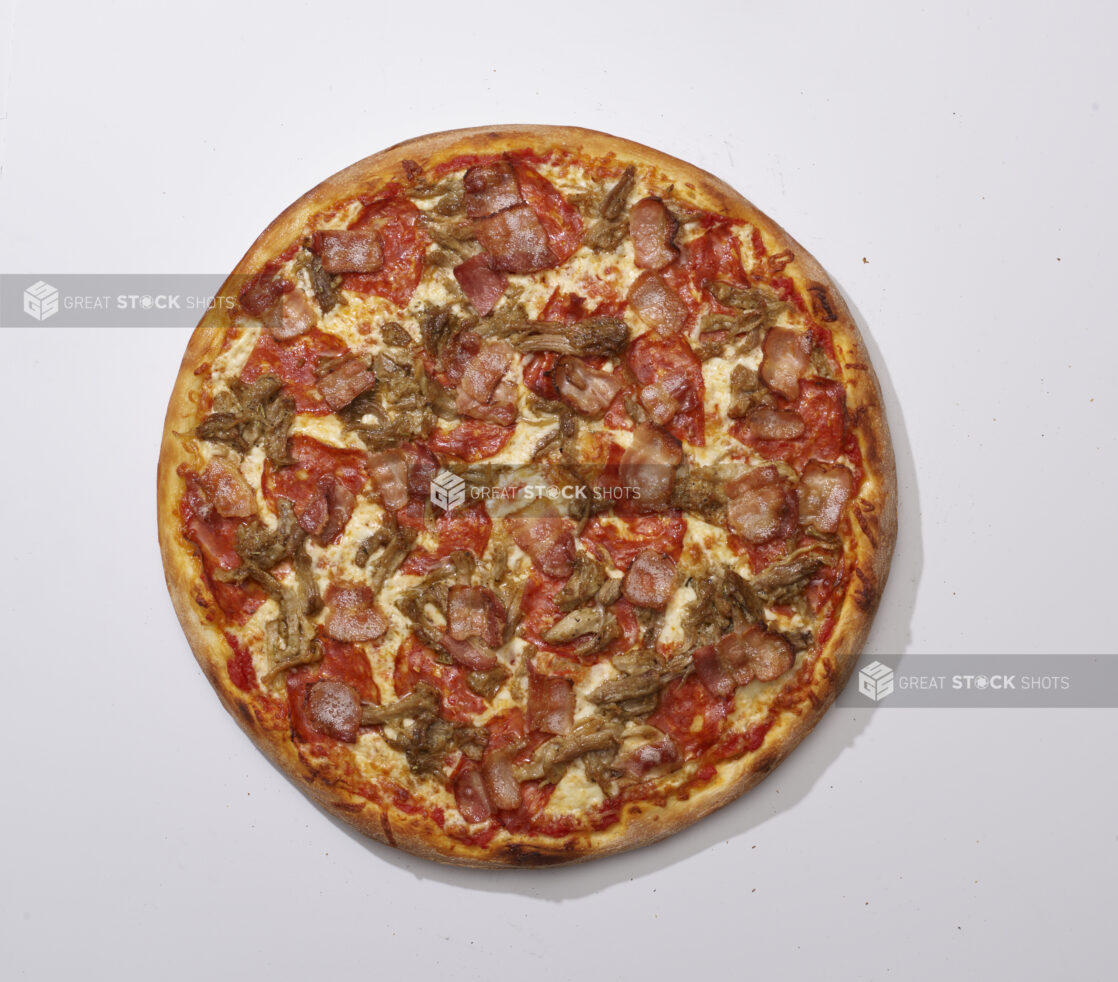 Overhead View of a Whole Specialty Pizza with Porchetta, Spicy Soppressata and Bacon Toppings, on a White Background for Isolation