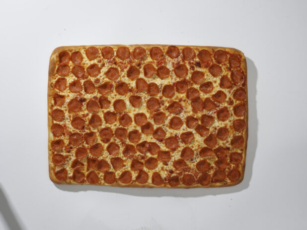 Overhead View of a Whole Party Pizza with Pepperoni and Cheese Toppings, on a White Background for Isolation