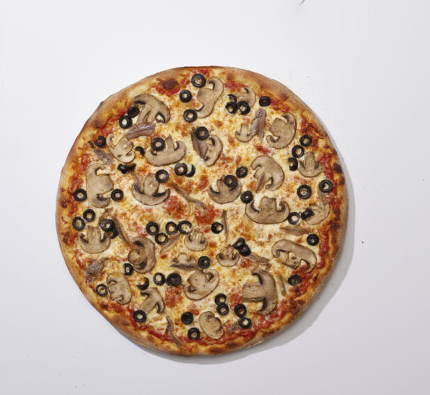 Overhead View of a Whole Specialty Pizza with White Mushrooms, Black Olives and Anchovies, on a White Background for Isolation