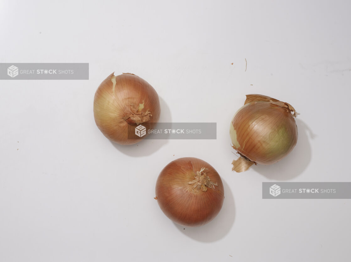 Overhead View of Whole Spanish Onions with Skin On, on a White Background for Isolation