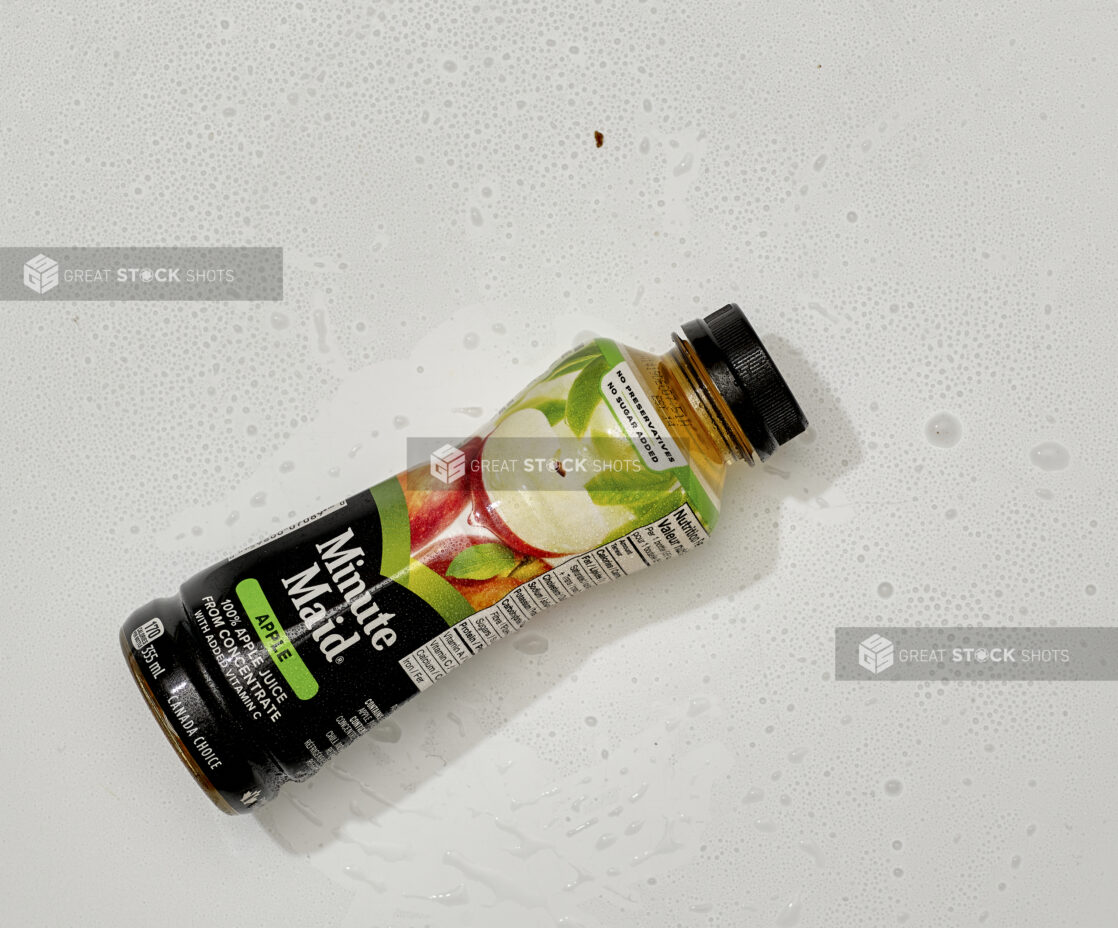 Overhead View of Minute Maid Brand Apple Juice in a Plastic Bottle, on a White Background for Isolation