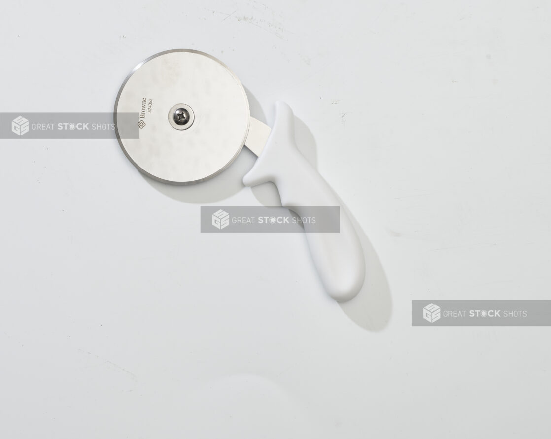 Overhead View of a Pizza Cutter with a White Handle, on a White Background for Isolation - Variation