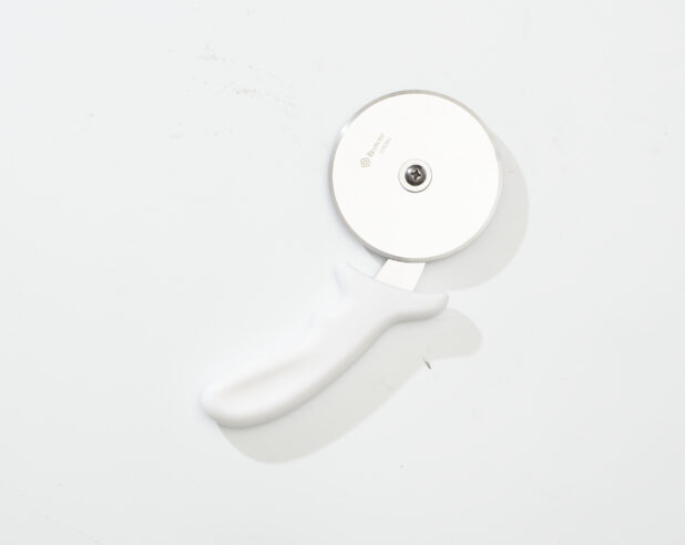 Overhead View of a Pizza Cutter with a White Handle, on a White Background for Isolation