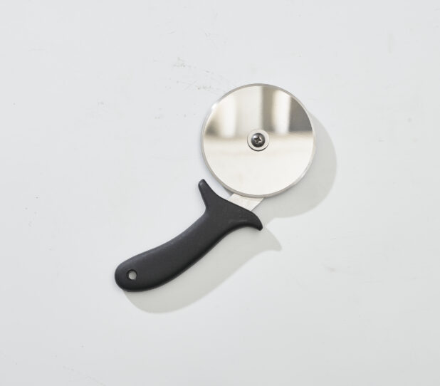 Overhead View of a Pizza Cutter with a Black Handle, on a White Background for Isolation