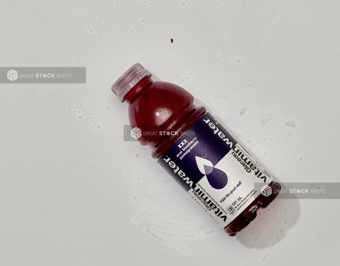 Overhead View of Glaceau VitaminWater Nutrient Enhanced Water in a Plastic Bottle, on a White Background for Isolation - Acai Bluberry Pomegranate