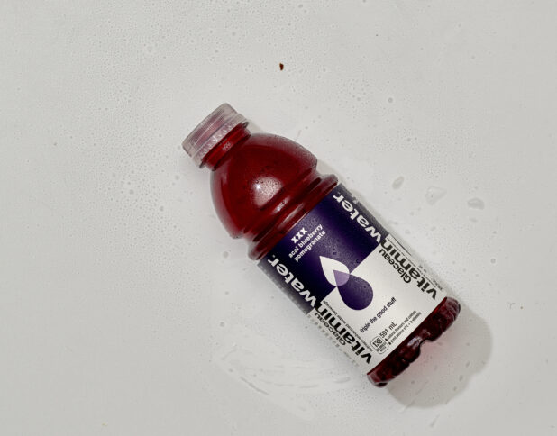 Overhead View of Glaceau VitaminWater Nutrient Enhanced Water in a Plastic Bottle, on a White Background for Isolation - Acai Bluberry Pomegranate