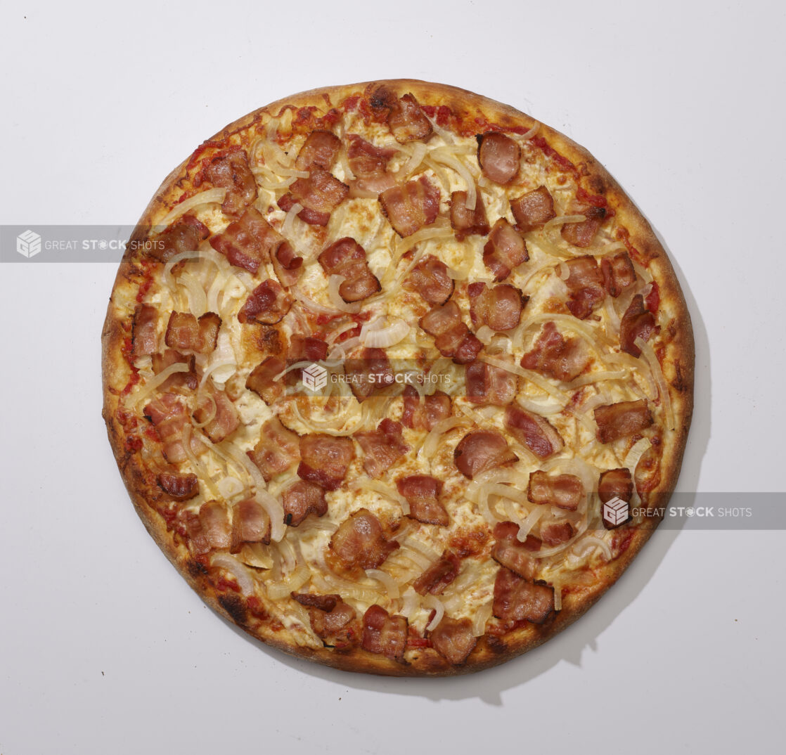 Overhead View of a Whole Specialty Pizza with Sliced White Onions and Bacon Toppings, on a White Background for Isolation