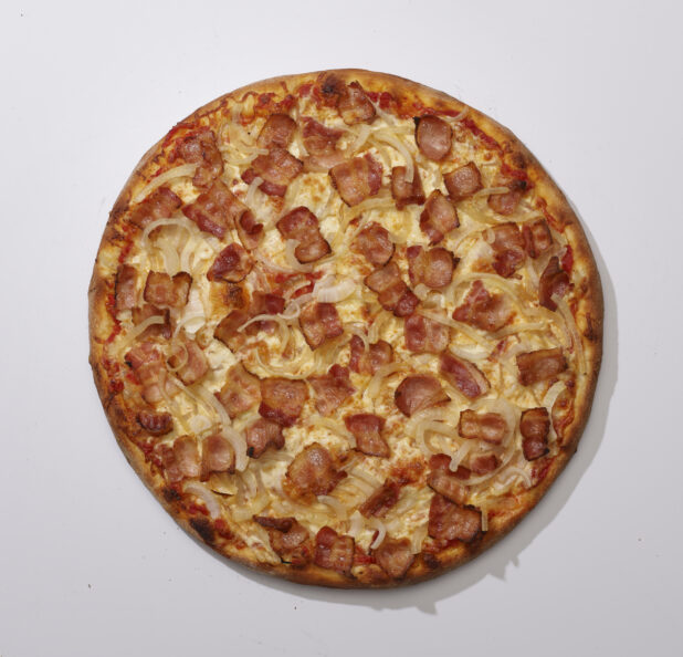 Overhead View of a Whole Specialty Pizza with Sliced White Onions and Bacon Toppings, on a White Background for Isolation