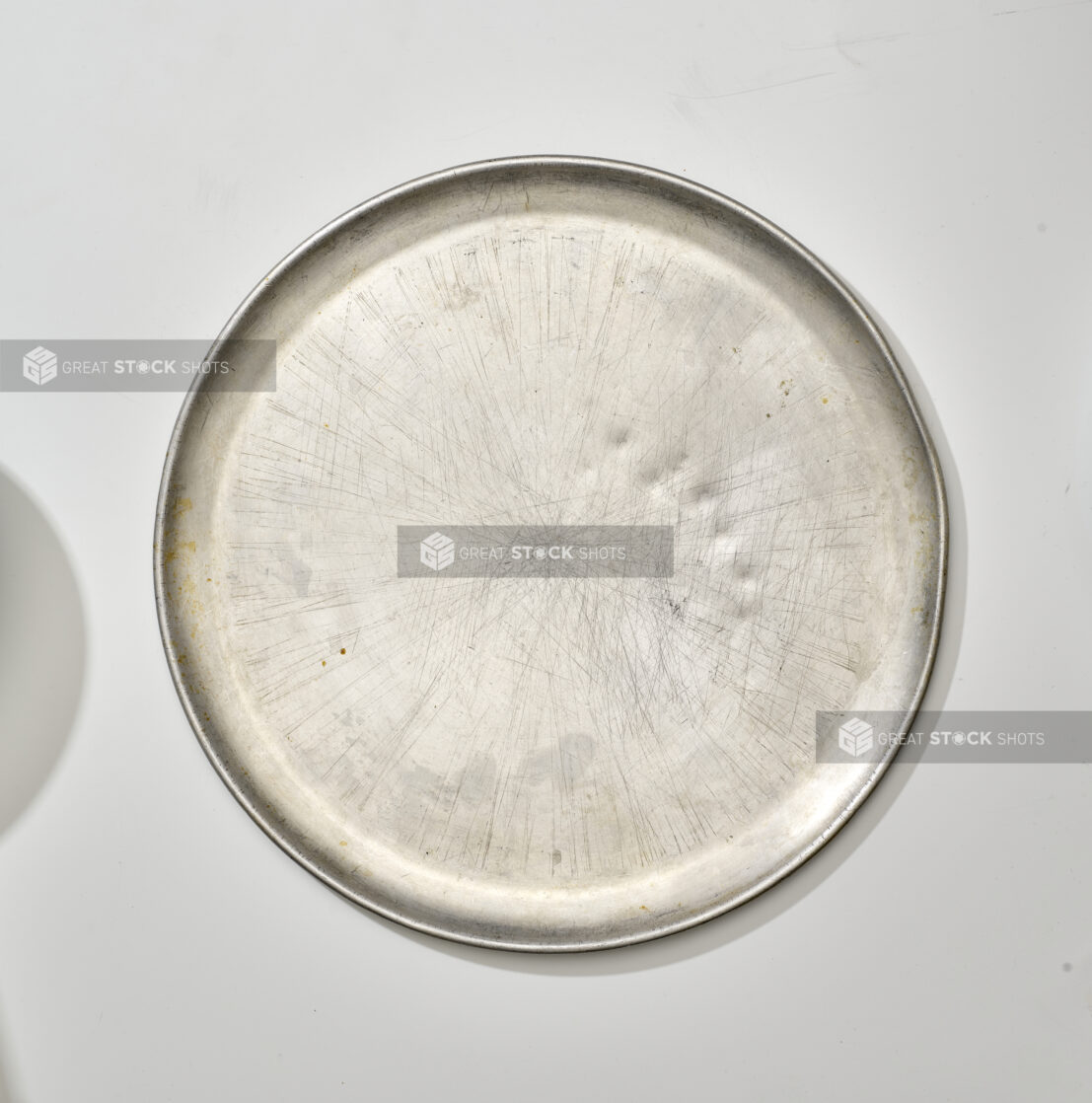 Overhead View of a Well Used Stainless Steel Pizza Tray, on a White Background for Isolation