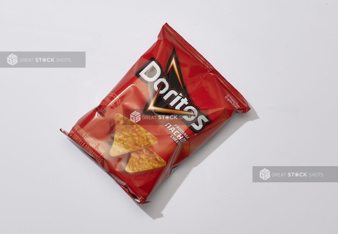 Overhead View of a Snack Bag of Nacho Cheese Flavoured Doritos Tortilla Chips, on a White Background for Isolation