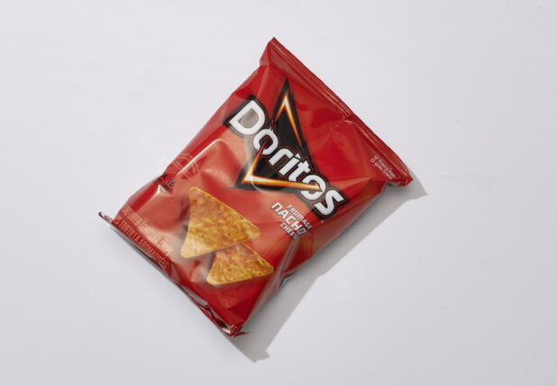 Overhead View of a Snack Bag of Nacho Cheese Flavoured Doritos Tortilla Chips, on a White Background for Isolation