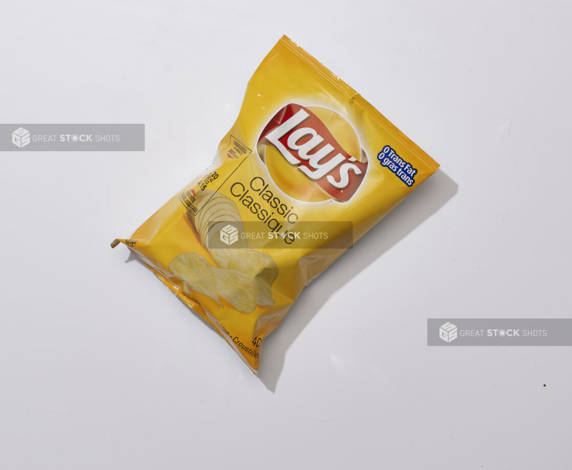 Overhead View of a Snack Bag of Classic Flavoured Lay's Potato Chips, on a White Background for Isolation