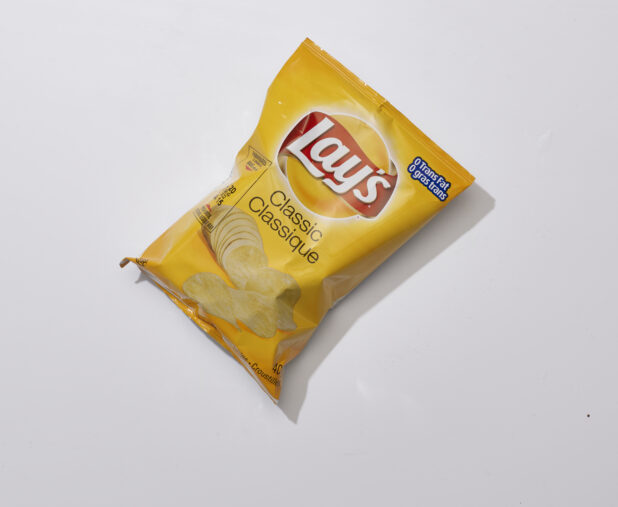 Overhead View of a Snack Bag of Classic Flavoured Lay's Potato Chips, on a White Background for Isolation