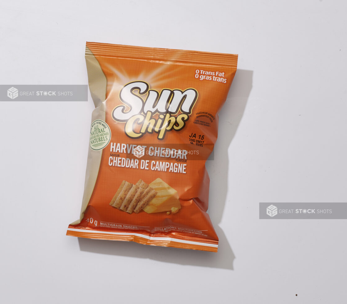 Overhead View of a Snack Bag of Harvest Cheddar Flavoured Sun Chips Multigrain Snacks, on a White Background for Isolation