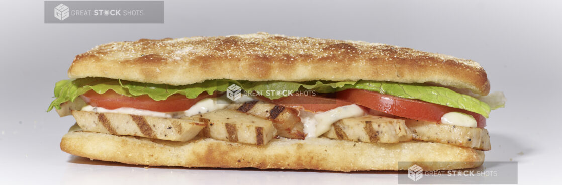 An Italian Sandwich with Grilled Chicken, Lettuce, Tomato and Mayo on Ciabatta Bread, on a White Background for Isolation