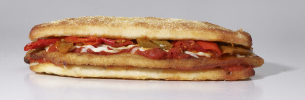 An Italian Cutlet Sandwich with Hot Peppers, Marinara Sauce and Cheese on Ciabatta Bread, on a White Background for Isolation