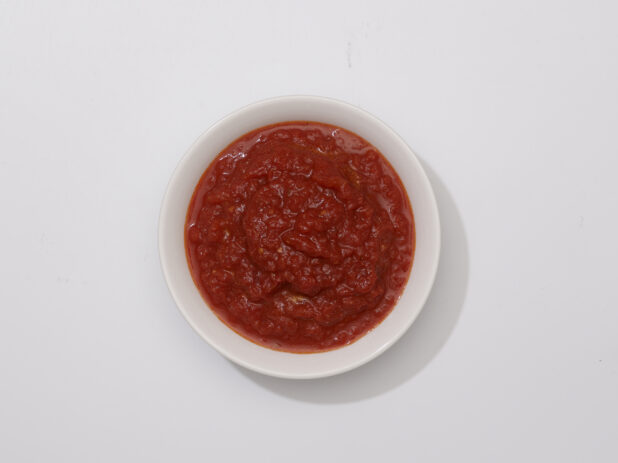 Overhead View of a Small Round Ceramic Bowl of Marinara Sauce, on a White Background for Isolation