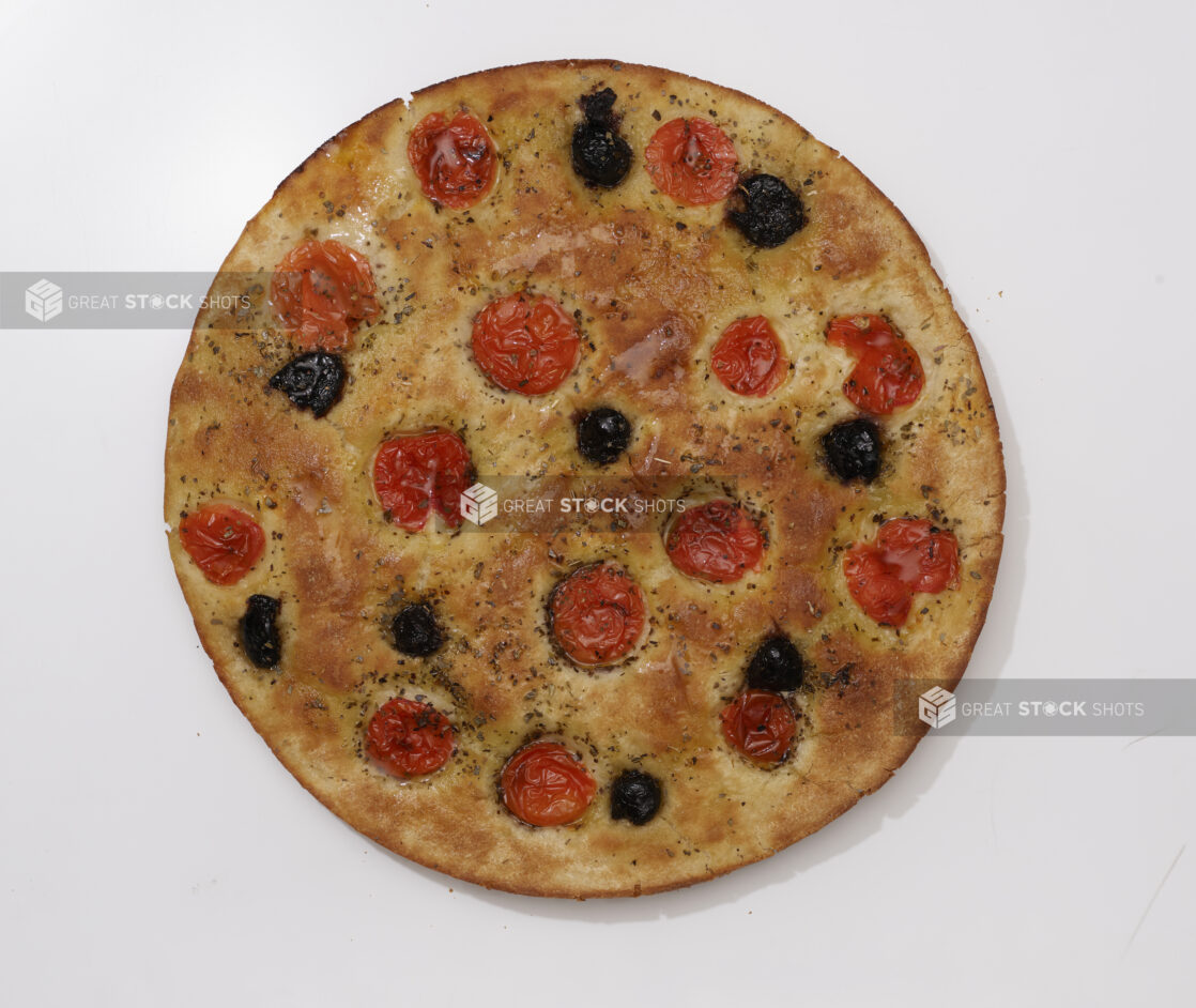 Overhead View of a Round Tomato and Black Olives Focaccia Bread, on a White Background for Isolation