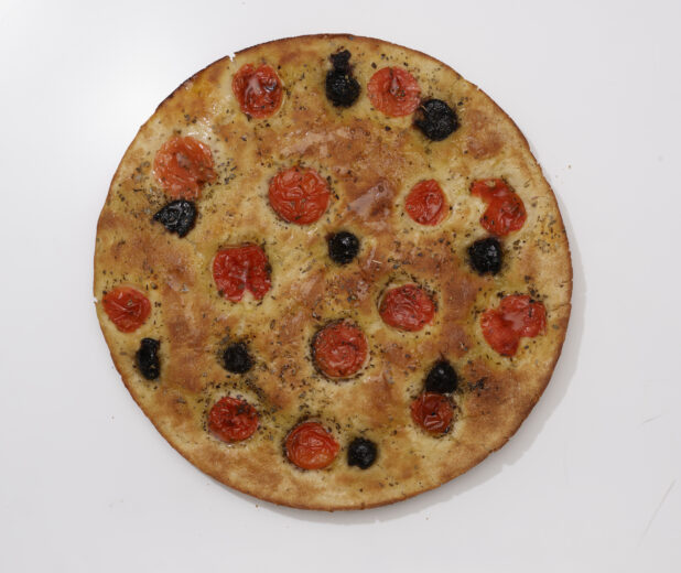 Overhead View of a Round Tomato and Black Olives Focaccia Bread, on a White Background for Isolation