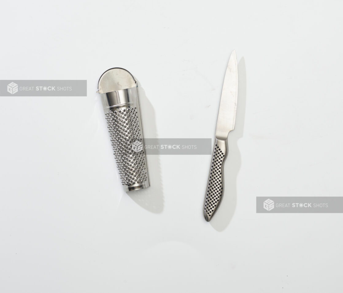 Overhead View of Stainless Steel Nutmeg Grater and Paring Knife, on a White Background for Isolation