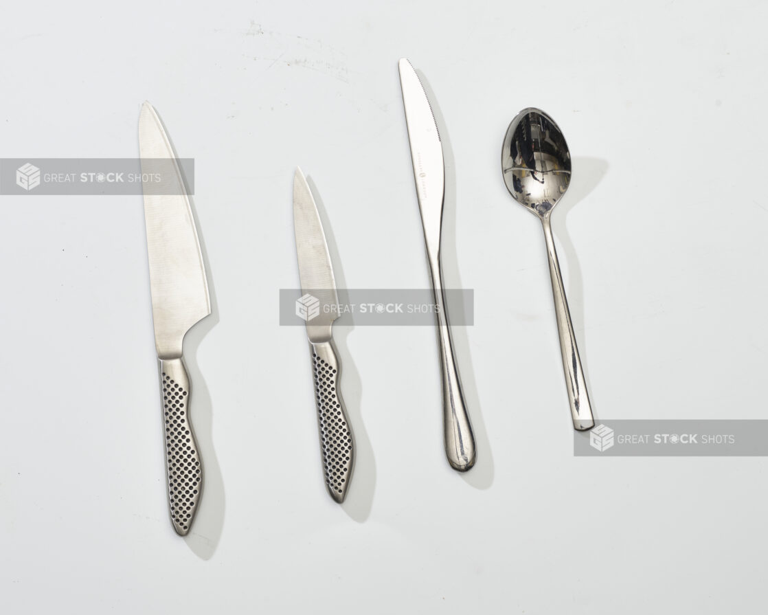 Overhead View of Kitchen Knife, Cheese Knife and Spoon, on a White Background for Isolation