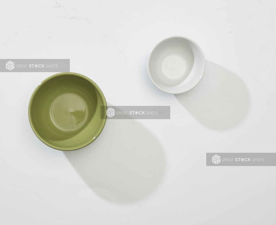 Overhead View of Olive Green and White Round Ceramic Dishes, on a White Background for Isolation