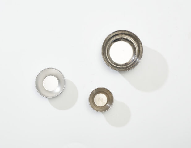 Overhead View of a Trio of Stainless Steel Metal Mixing Bowls, on a White Background for Isolation