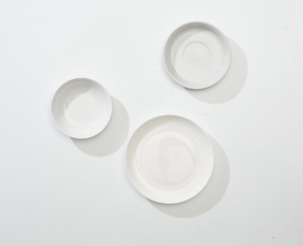 Overhead View of a Trio of White Round Ceramic Dishes, Plates and Bowls, on a White Background for Isolation