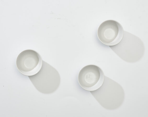 Overhead View of a Trio of White Round Ceramic Dishes, on a White Background for Isolation