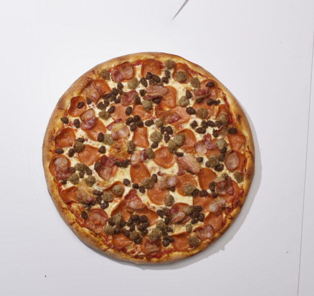 Overhead View of a Whole Meat Lovers Pizza with Pepperoni, Bacon, Italian Sausage and Ground Beef, on a White Background for Isolation