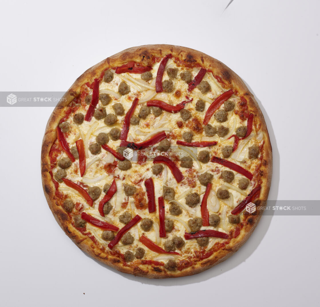 Overhead View of a Whole Pizza with Roasted Red Pepper, White Onion and Italian Sausage Bits, on a White Background for Isolation