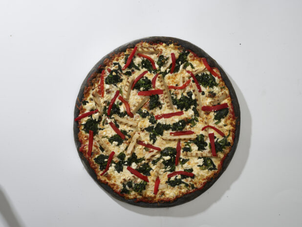 Overhead View of a Whole Charcoal-Infused Pizza with Grilled Chicken, Roasted Red Peppers and Sautéed Spinach Toppings, on a White Background for Isolation