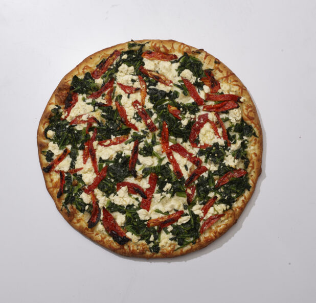 Overhead View of a Whole Pizza with Sautéed Spinach, Roasted Red Peppers and Feta Cheese, on a White Background for Isolation