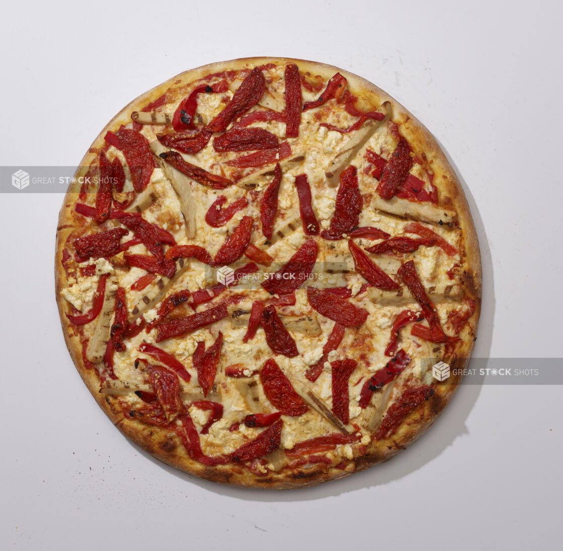 Overhead View of a Whole Specialty Pizza with Sun-dried Tomato, Roasted Red Pepper, Grilled Chicken and Feta Cheese, on a White Background for Isolation