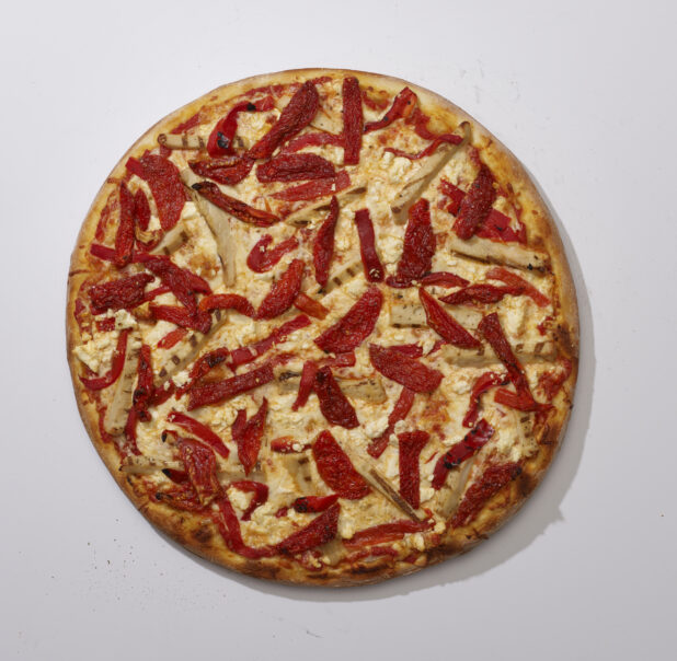 Overhead View of a Whole Specialty Pizza with Sun-dried Tomato, Roasted Red Pepper, Grilled Chicken and Feta Cheese, on a White Background for Isolation