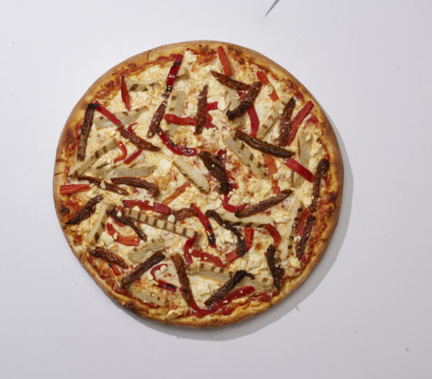 Overhead View of a Whole Specialty Pizza with Sliced White Onions, Roasted Red Peppers, Feta Cheese and Grilled Chicken Toppings, on a White Background for Isolation