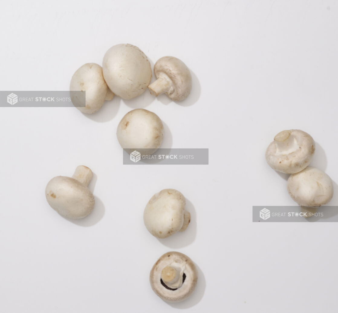 Overhead View of a Cluster of Whole White Mushrooms, on a White Background for Isolation