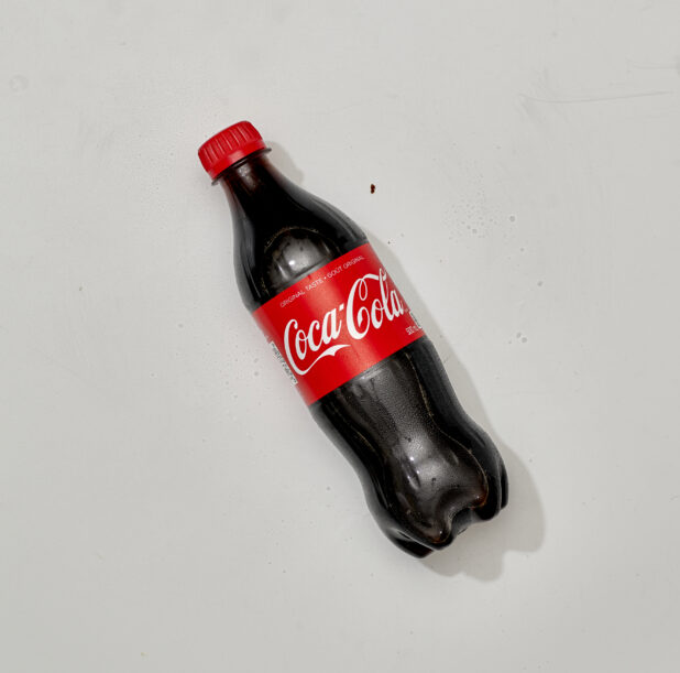 Overhead View of Coca-Cola in a Plastic Bottle, on a White Background for Isolation