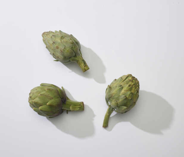 Whole artichokes on a white background