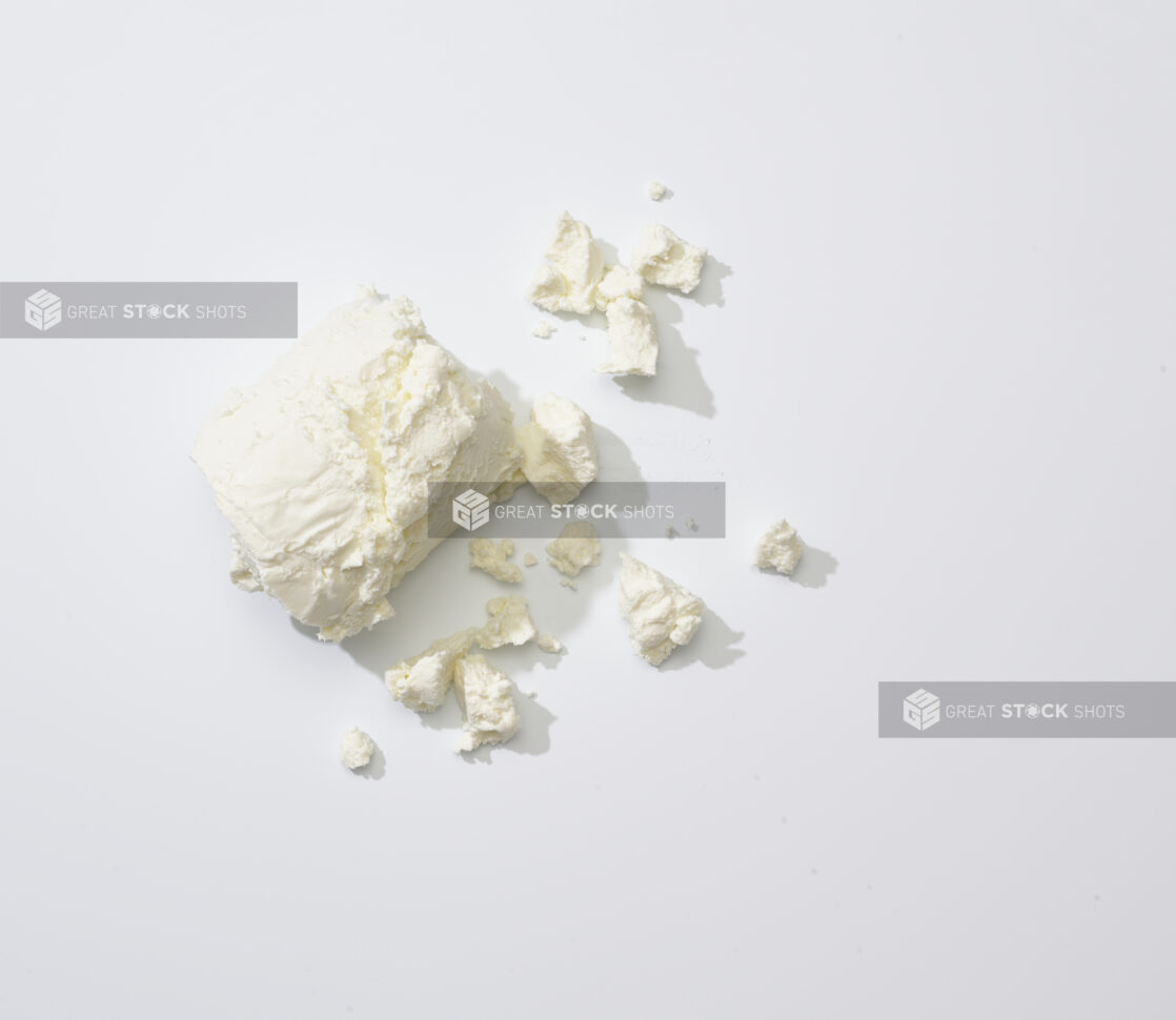 Crumbled goat cheese on a white background