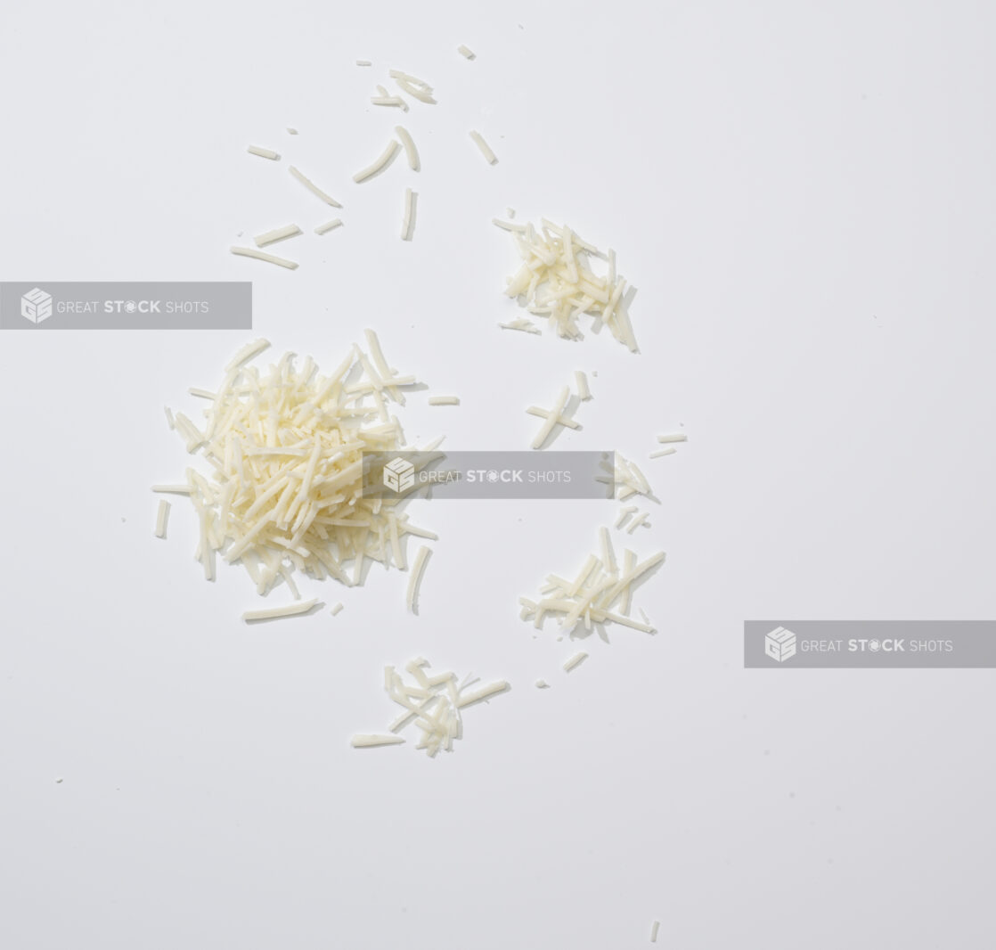 Coarsely grated Parmesan on a white background